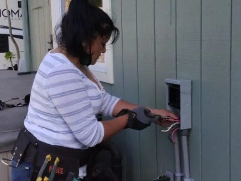 Licensed electrician wiring an exterior subpanel in Woods Creek